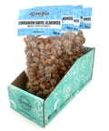 5 bags of candied almonds in clear bags with blue labels on top.