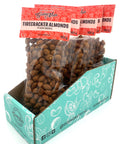 5 clear bags of spiced almonds with red labels on top.