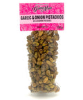A clear bag of spiced pistachios with a pink label on top.