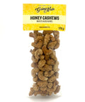 A clear bag of candied cashews with a yellow label on top.