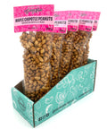 5 clear bags of candied and spiced peanuts with pink labels on top.
