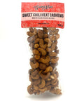 A clear bag of spiced cashews with a red label on top.