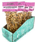 5 clear bags of spiced cashews with purple labels on top.