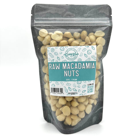 A black zippered bag filled with macadamia nuts with a clear front and a blue and white label on the front