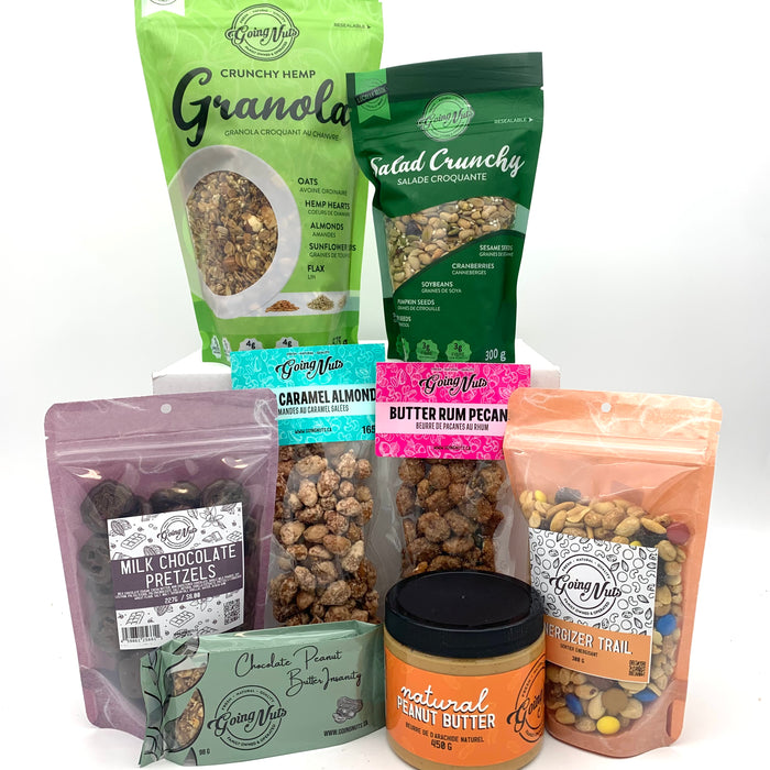A colourful mix of various bags of nuts, granola, granola bar and a jar of nut butter.