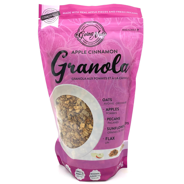 A purple zippered bag which has a window in the shape of a circle to reveal the granola underneath; a mix of oats, apples, and pecans. 
