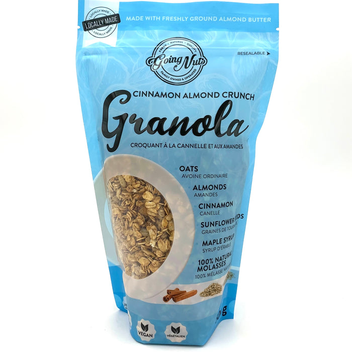 A blue zippered bag which has a window in the shape of a circle to reveal the granola underneath; a mix of oats, almonds, and sunflower seeds.