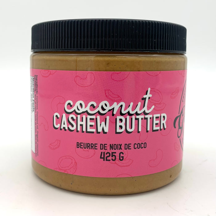 A jar of light brown nut butter with a pink label which has a cashew and coconut motif.