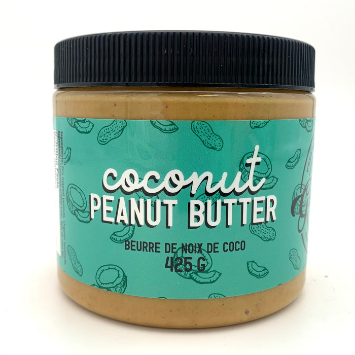 A jar of light brown nut butter with a teal label which has a peanut and coconut motif.