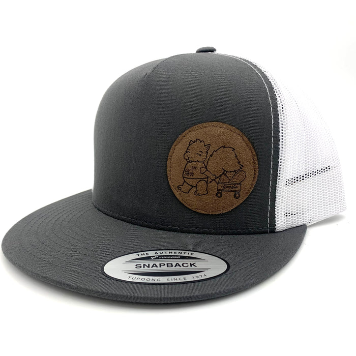 A side view of a cap with a dark grey front and a white mesh back, with a brown logo of a squirrel pulling a wagon on the right half.