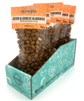 5 clear bags of spiced almonds with orange labels on top.