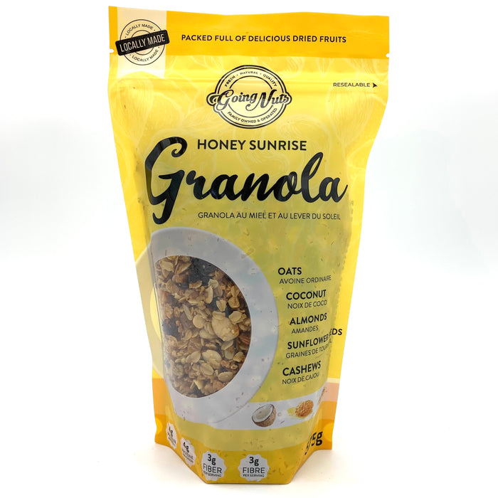 A bright yellow zippered bag which has a window in the shape of a circle to reveal the granola underneath; a mix of oats, almonds and raisins.