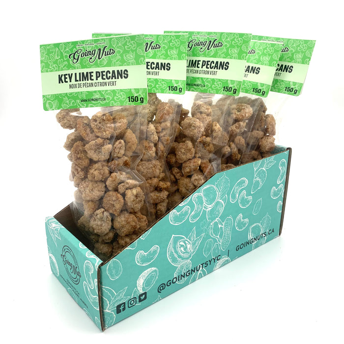 5 clear bags of candied pecans with green labels on top.