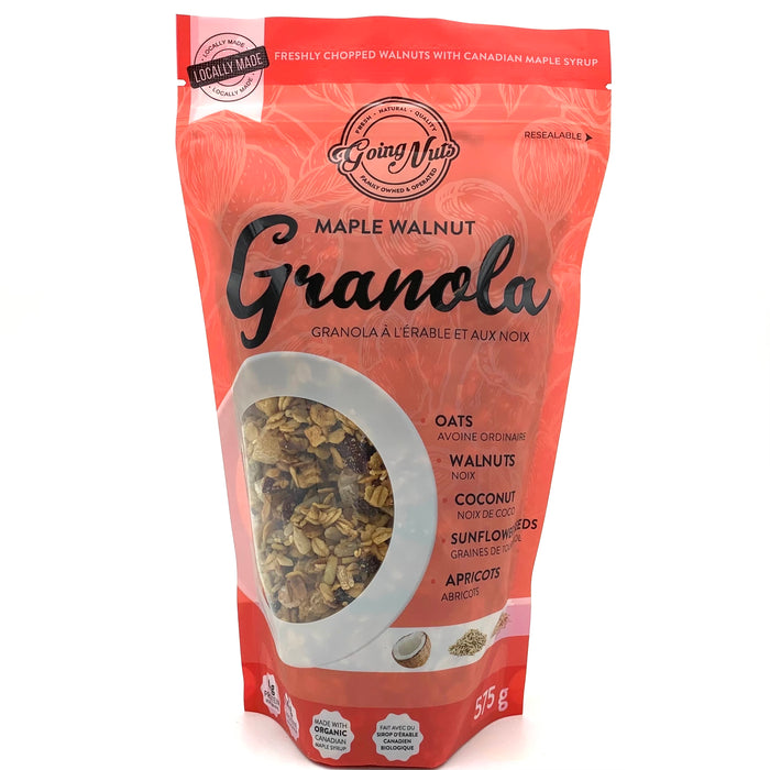 A red zippered bag which has a window in the shape of a circle to reveal the granola underneath; a mix of oats, walnuts, and apricots.