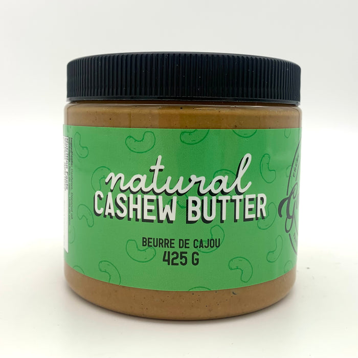 A jar of brown nut butter with a light green label which has a cashew motif.
