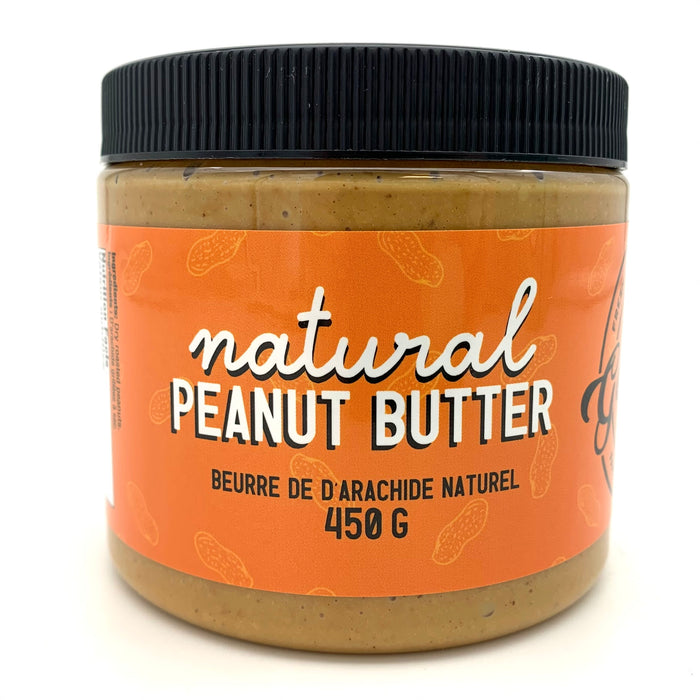 A jar of peanut butter with an orange label which has a peanut motif.