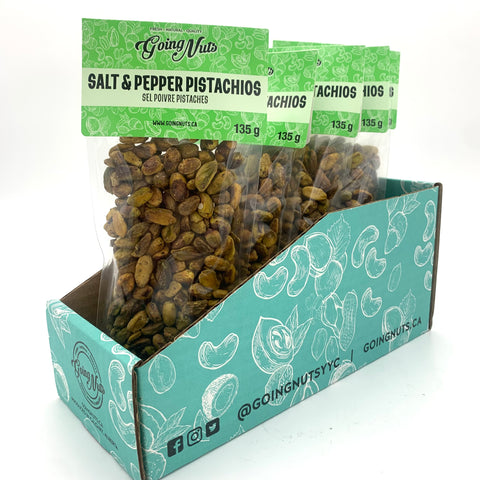 5 clear bags of spiced pistachios with green labels on top.