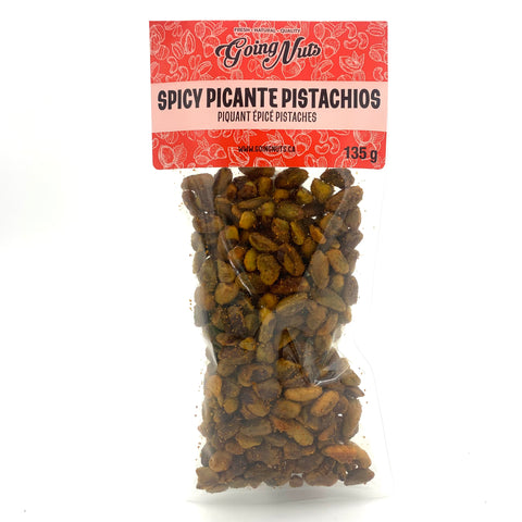 A clear bag of spiced pistachios with a red label on top.