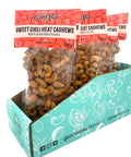 5 clear bags of spiced cashews with red labels on top. 