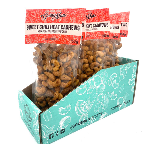 5 clear bags of spiced cashews with red labels on top. 