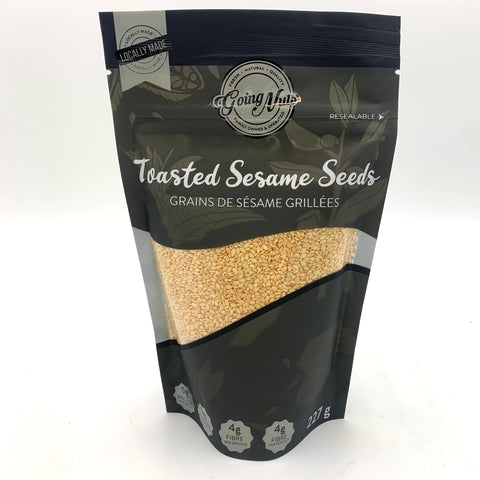 A black zipper bag with a window swooping up from left to right revealing golden toasted sesame seeds.