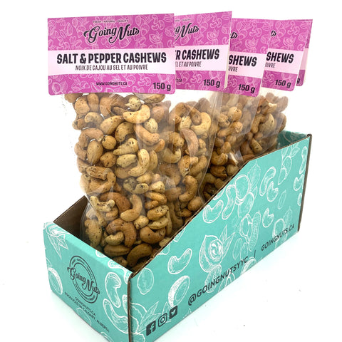 5 clear bags of spiced cashews with purple labels on top.