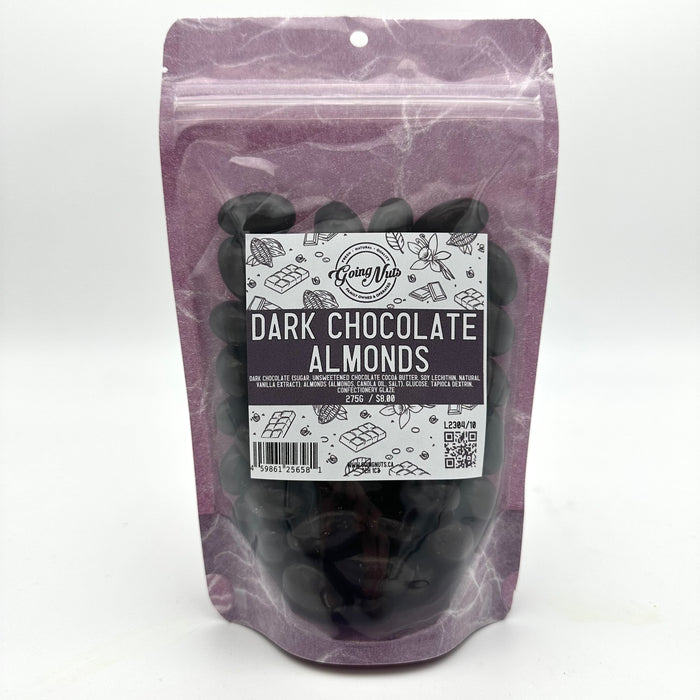 A purple bag with a clear front is filled with dark chocolate almonds with a white and purple label on the front 