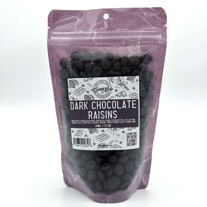 A purple bag with a clear front is filled with black dark chocolate raisins with a white and purple label on the front. 