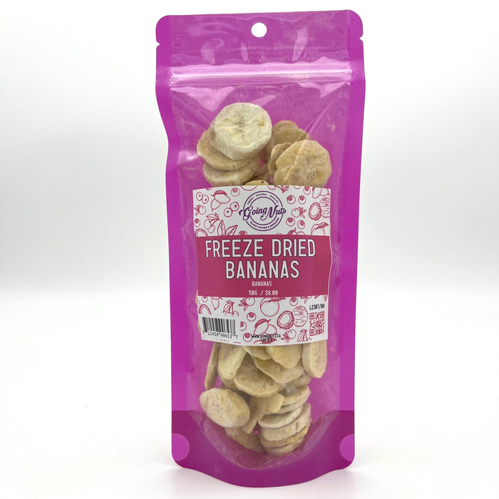 A bright pink bag with a clear front is filled with sliced freeze-dried bananas with a white and pink label on the front 