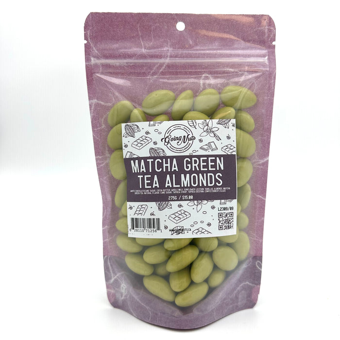 A purple bag with a clear front is filled with green chocolate almonds with a white and purple label on the front 