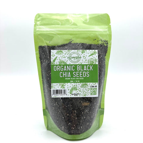 A light green zippered bag filled with black chia seeds with a clear front and a green and white label on the front