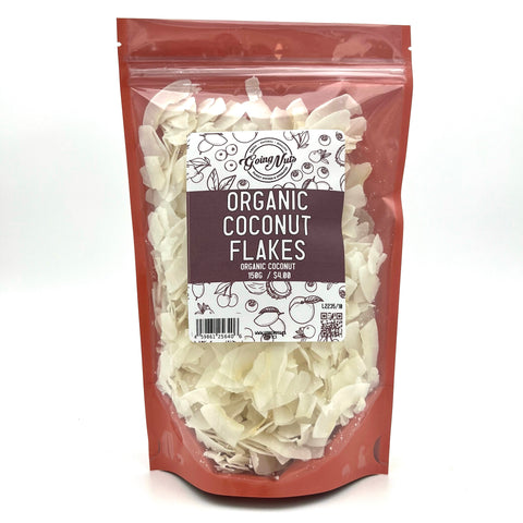 A pink bag with a clear front is filled with white coconut flakes with a white and pink label on the front 