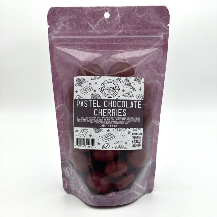 A purple bag with a clear front is filled with red chocolate cherries with a white and pink label on the front.
