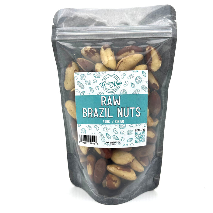 A black zippered bag filled with raw brazil nuts with a clear front and a teal and white label on the front