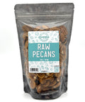A black zippered bag filled with raw pecans with a clear front and a blue and white label on the front