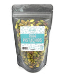 A black zippered bag filled with pistachios with a clear front and a teal and white label on the front