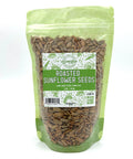 A light green zippered bag filled with roasted sunflower seeds with a clear front and a green and white label on the front